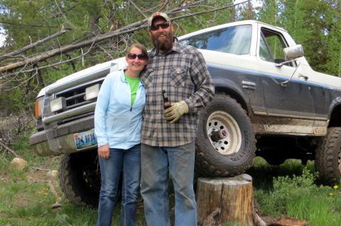 1989 Ford Bronco - A couple poses in front of a lifted 1987 Ford Bronco, likely taken on a trip.