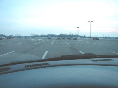 1997 Ford Taurus - A wide view of a parking lot with several cars visible, taken from the perspective of someone inside a vehicle.