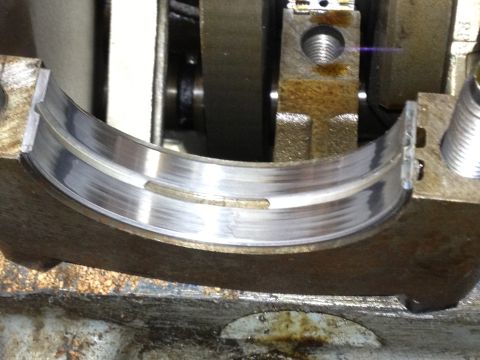 1961 International Scout 800 - Worn engine bearing showing signs of scoring and damage.
