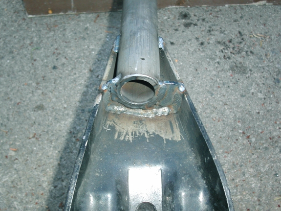 Tube welded into body of arm. Note the slight offset and that it's not flat against the inside of the arm, this is to add approx 5 degree of caster angle to the axle, along with a bit more tire clearance too.