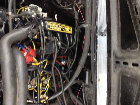 1988 Ford Bronco - Close-up view of a vehicle's engine bay, highlighting the electronic fuel injection system and associated wiring.