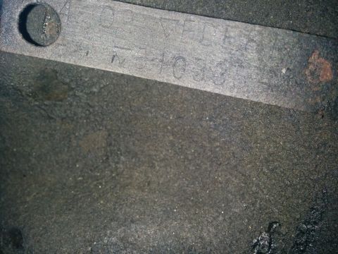 1988 Ford Bronco - Close-up of a metal plate with stamped identification numbers and letters.