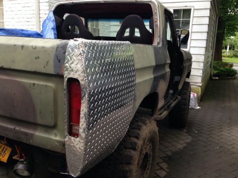 1979 Ford Bronco - This modified Ford Bronco, likely from the late 1970s, features racing seats and a custom rear panel.