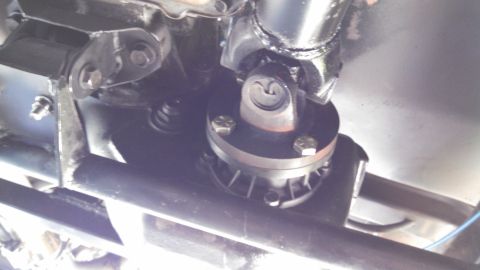 1967 Ford F-250 - Close-up view of a vehicle's driveshaft U-joint and its mounting bracket.