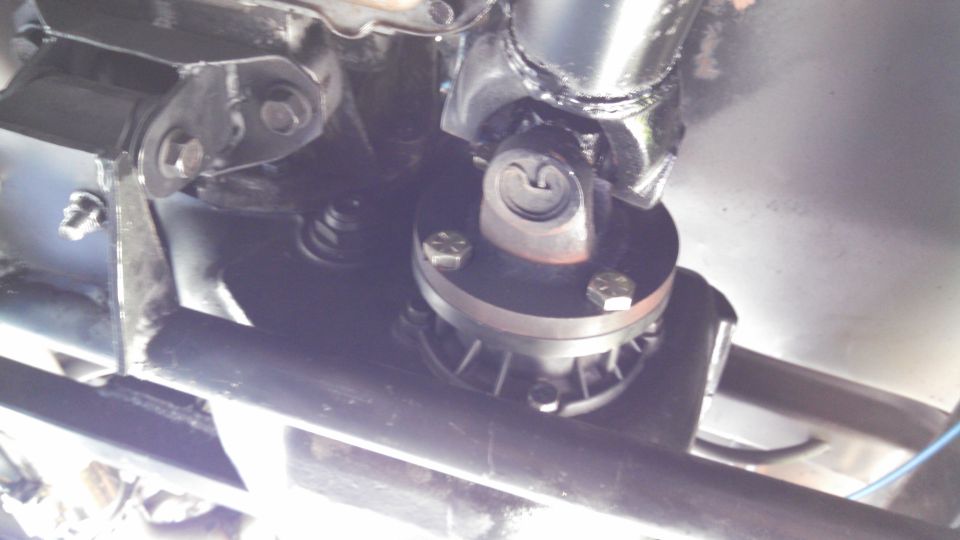 Driveshaft U-joint and mounting bracket on underside of vehicle