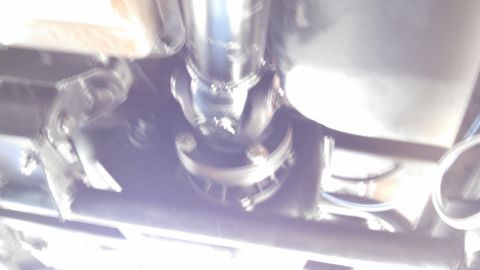 1967 Ford F-250 - Underside view of a vehicle's driveshaft and U-joint, showing mechanical components.