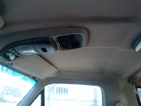 1996 Ford Bronco - The interior ceiling console of a 1996 Ford Bronco features overhead lights and a visor.