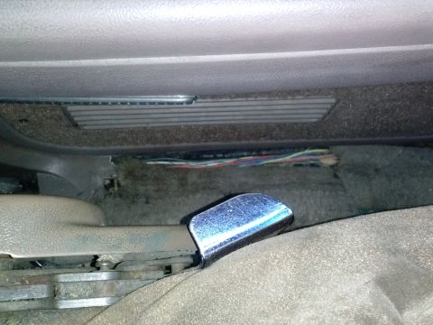 1996 Ford Bronco - Exposed wiring and components are visible beneath the seat of the vehicle.