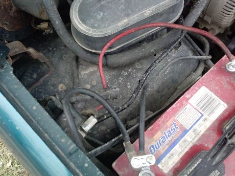 1996 Ford Bronco - The engine bay shows a Duralast battery and various electrical connections and hoses.