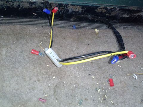 1996 Ford Bronco - Close-up of a vehicle's wiring harness with multiple connectors and a junction block.