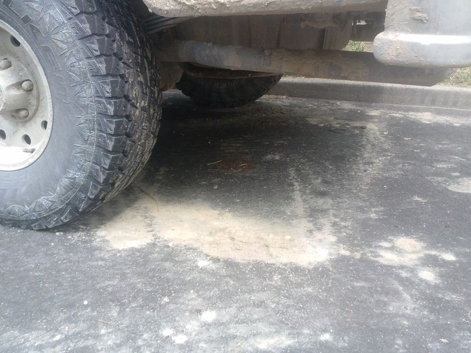 Close-up of a large tire and undercarriage of a vehicle