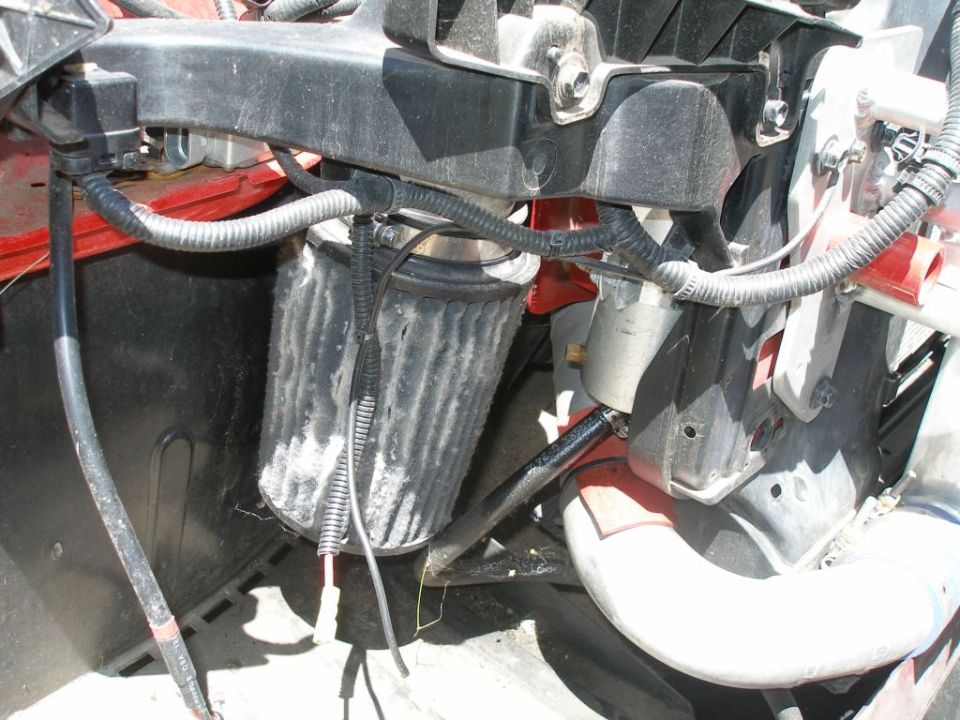 Engine bay shot showing an air filter and associated hoses and wiring