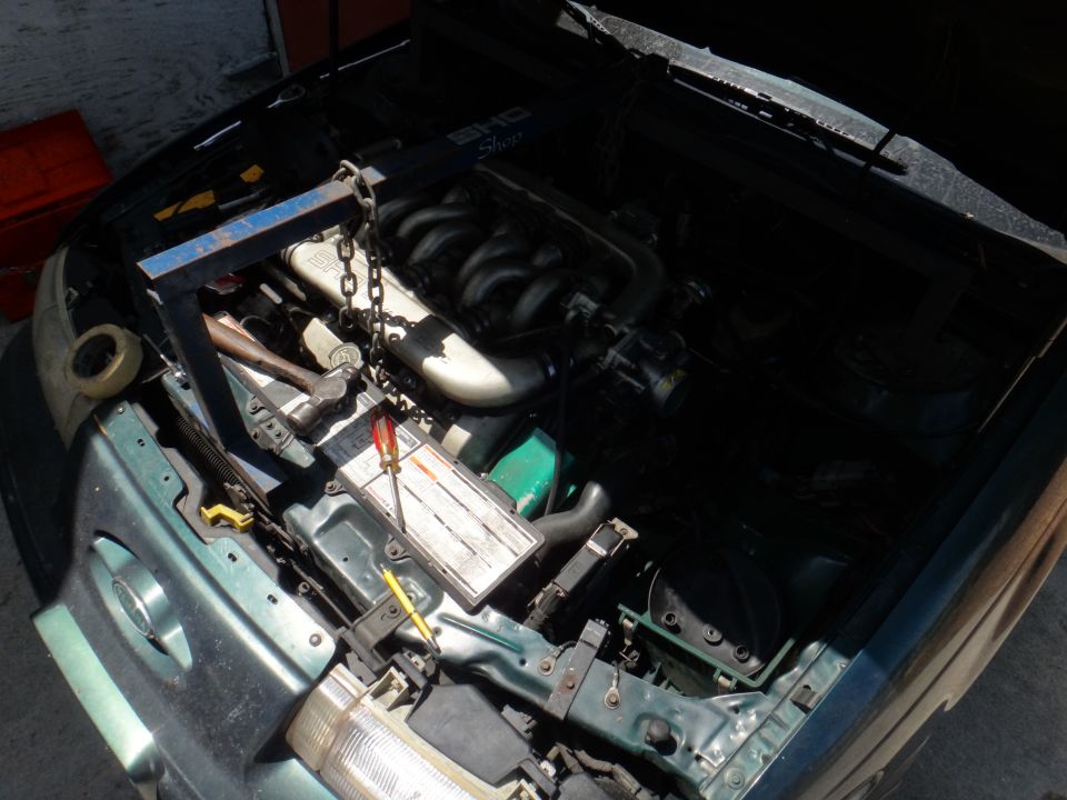1993 Ford Taurus engine bay with engine hoist and V6 engine