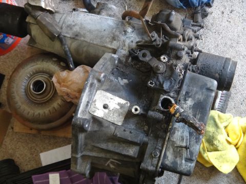 1993 Ford Taurus - Transmission and torque converter assembly shown on a carpeted surface, likely for repair or sale.