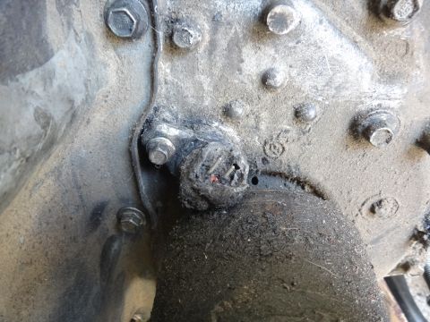1993 Ford Taurus - A close-up view of a heavily soiled mechanical component, possibly from a vehicle's transmission or differential.