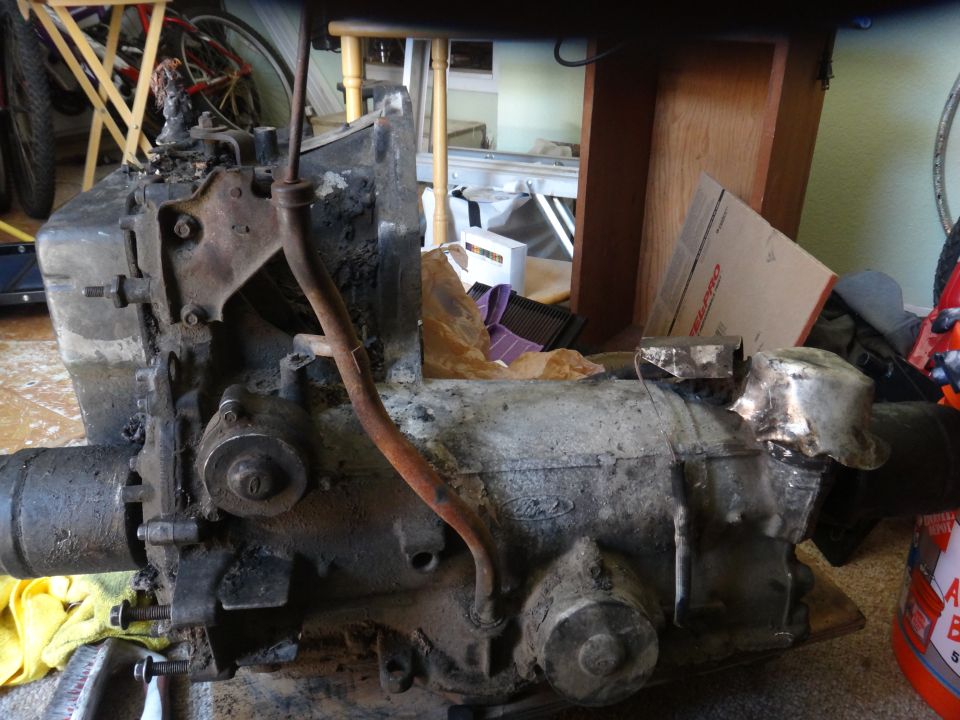 Dirty transmission with a Ford logo visible