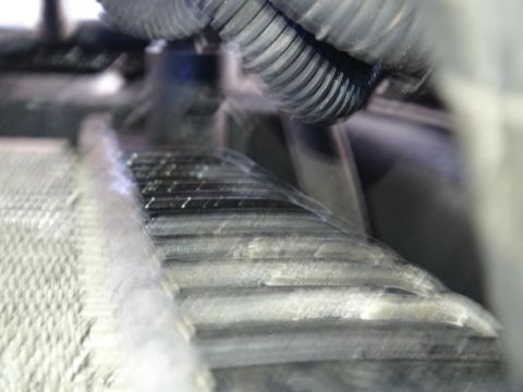 1993 Ford Taurus - Close-up view of radiator fins and engine hoses.
