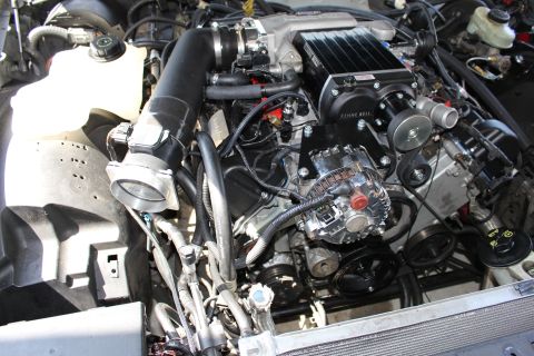 2003 Ford Crown Victoria - Engine bay featuring a Kenne Bell supercharger atop the intake manifold with throttle body, alternator and accessory drive pulleys.