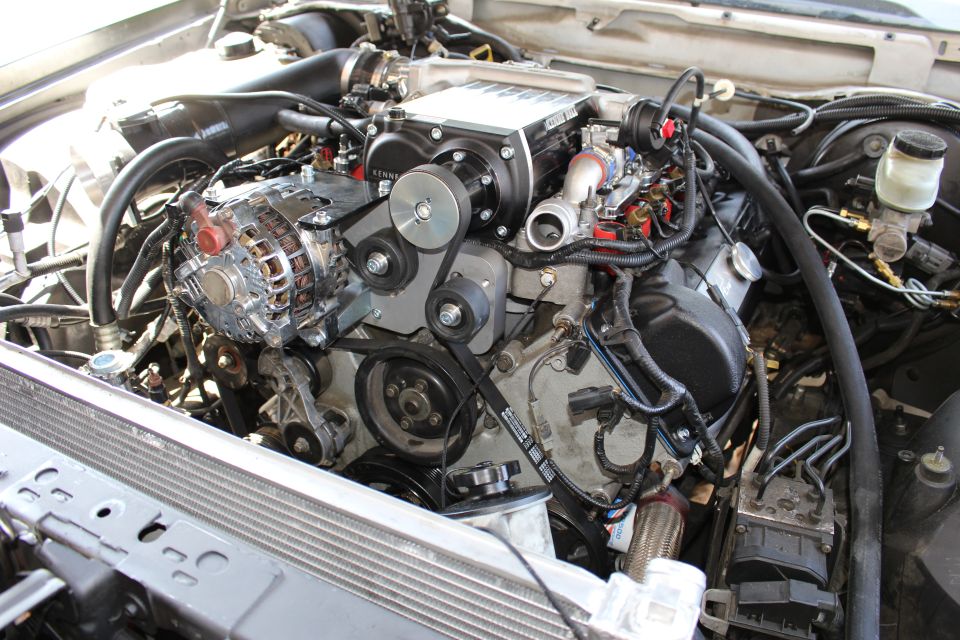 Angled engine bay shot of a supercharged V8 with chrome alternator and pulleys