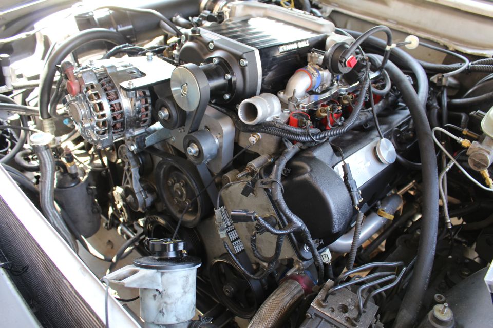 Engine showing chrome alternator, black supercharger drive and oil filter