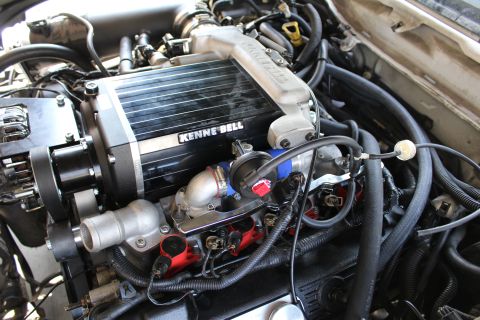 2003 Ford Crown Victoria - top-down view of a Kenne Bell supercharger with throttle body, red ignition coils and braided fuel lines.