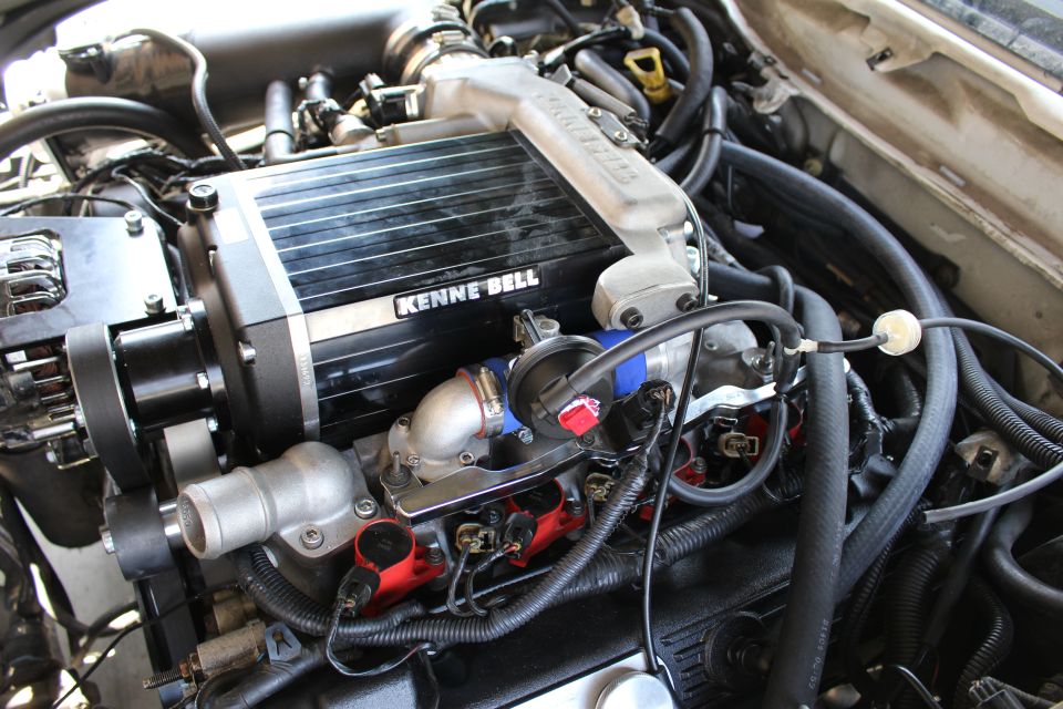 Top view of Kenne Bell supercharger with throttle body and red coils