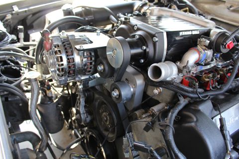 2003 Ford Crown Victoria - engine view focused on a polished alternator, supercharger drive pulleys and a metal throttle body inlet.