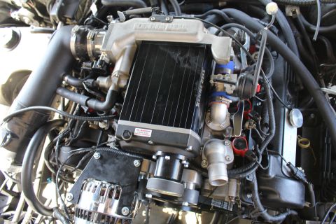 2003 Ford Crown Victoria - Kenne Bell supercharger with a finned intercooler core, throttle body and a warning label on the housing.