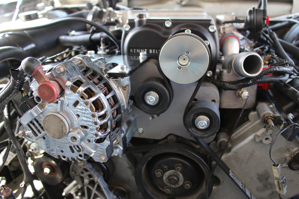 Chrome alternator and idler pulleys beneath a Kenne Bell supercharger
