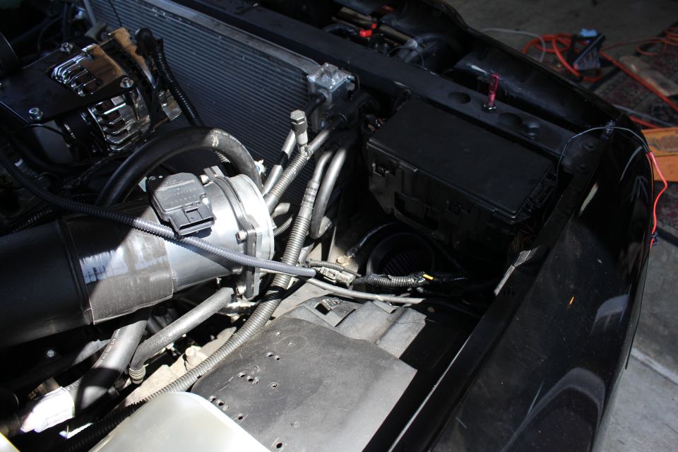 Engine bay with intake tube, fuse box and radiator support
