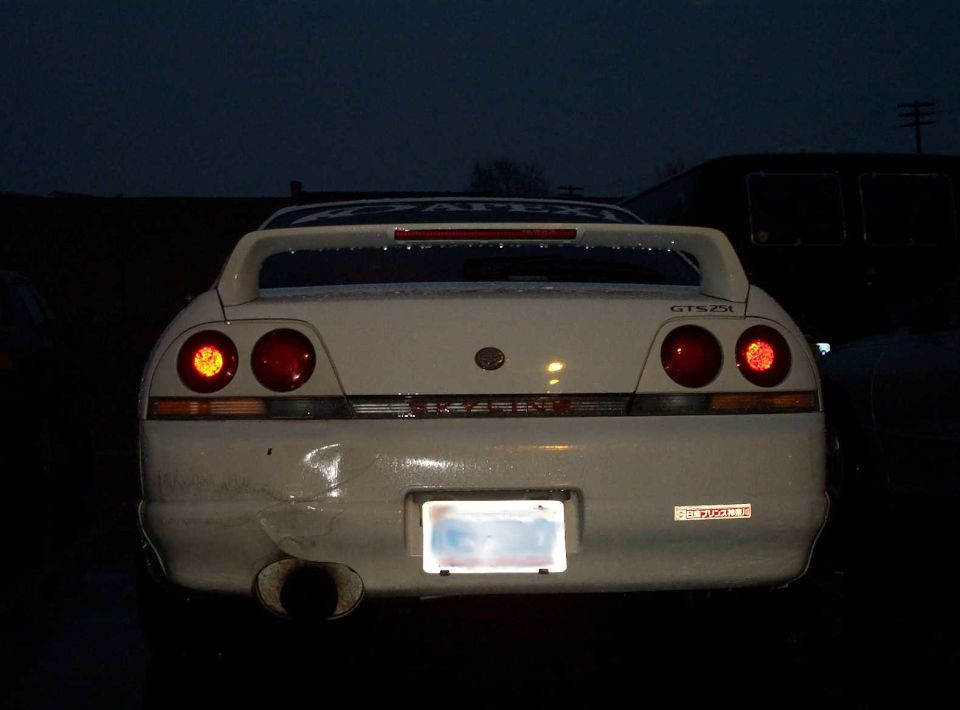 White Nissan Skyline R33 GTS25t rear view at dusk with quad round taillights and wing