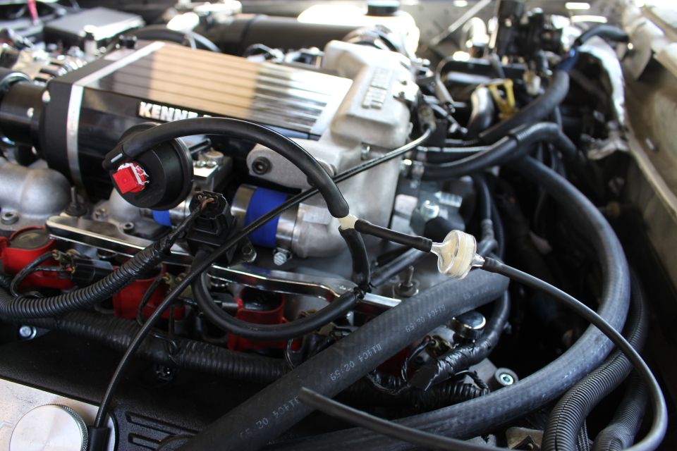 Kenne Bell supercharger atop an engine with red coil packs