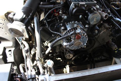 2003 Ford Crown Victoria - Tight close-up of a chrome alternator with red-capped post beside Kenne Bell supercharger pulleys and serpentine belt.