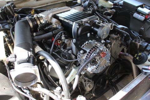 2003 Ford Crown Victoria - Close engine bay view of a Kenne Bell supercharger mounted above a polished chrome alternator and serpentine belt.