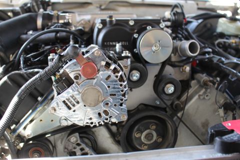2003 Ford Crown Victoria - Tight close-up of a polished chrome alternator beside the Kenne Bell supercharger pulley and serpentine belt drive.