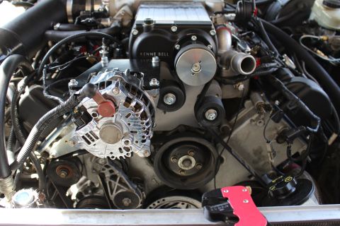 2003 Ford Crown Victoria - Engine bay close-up showing a chromed alternator beside a black Kenne Bell supercharger and accessory drive pulleys.