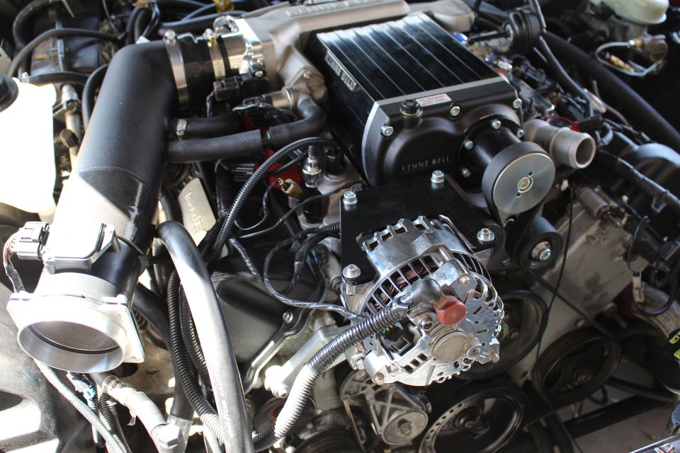 Kenne Bell supercharger with black intake hose in engine bay