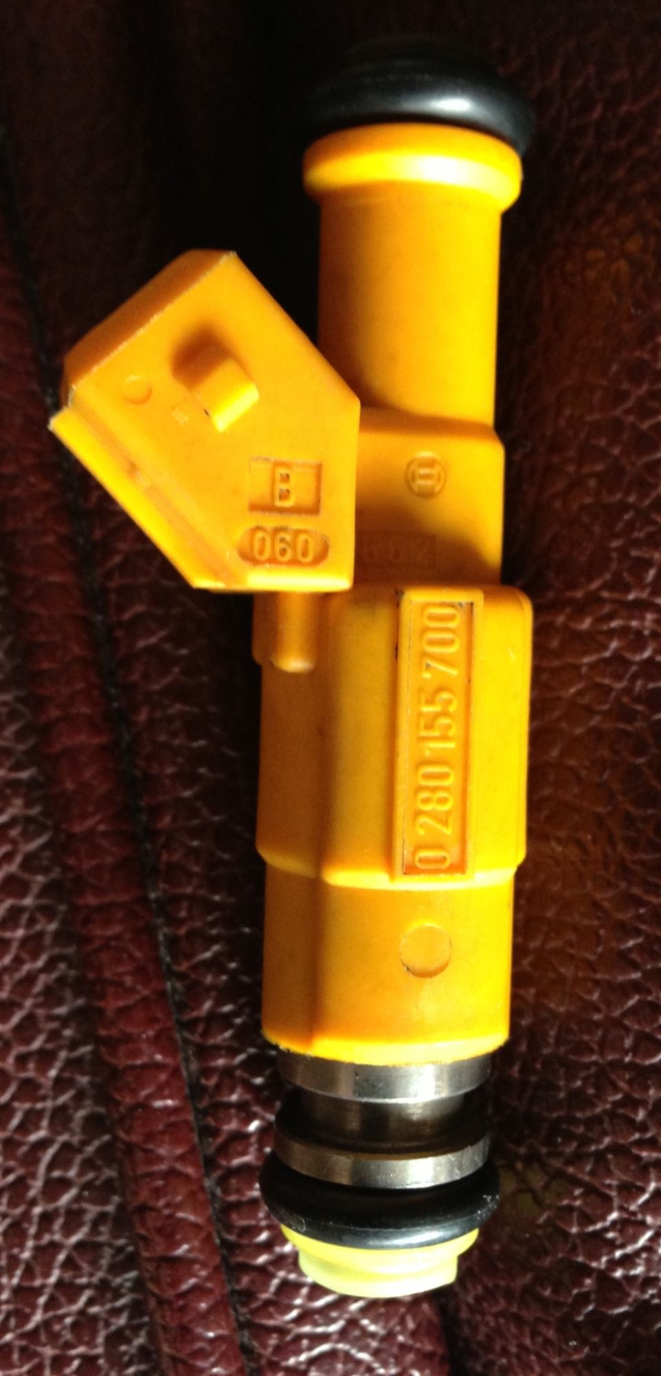 Yellow Bosch fuel injector with part number 0 280 155 700