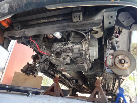 1993 Ford Taurus - Car's underside exposed for maintenance, revealing transmission and suspension details.