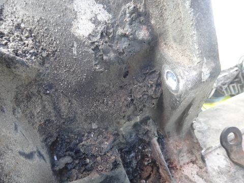 1993 Ford Taurus - Close-up of a severely damaged engine part, showing extensive corrosion and material loss.