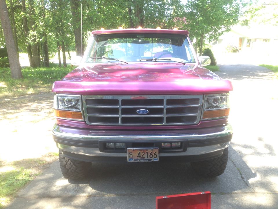 Front view of a 1992 Ford F-150 pickup truck with a purple paint job and a chrome grille
