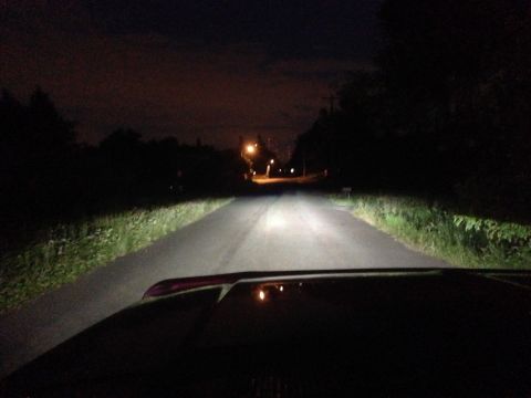 1992 Ford F-150 - Driving at night on a dark road, headlights illuminate the path ahead. The Supermotors.net logo is visible.