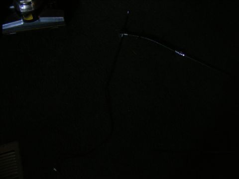 Black interior with a chrome and black interior light fixture on the upper left