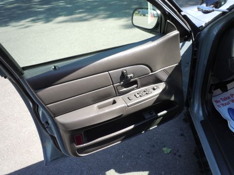 2001 Ford Crown Victoria - Interior view of a 2001 Ford Crown Victoria, focusing on the driver's side door panel and controls.