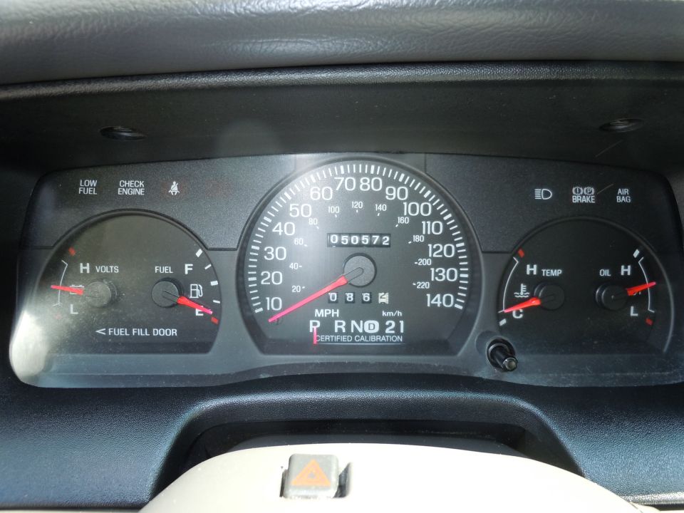 Car dashboard with speedometer, fuel gauge, voltage meter, temperature gauge, and oil gauge. Odometer shows 050572