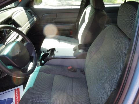 2001 Ford Crown Victoria - Interior view of a 2001 Ford Crown Victoria, highlighting the front seating area and dashboard.