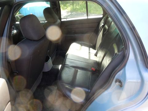 2001 Ford Crown Victoria - Rear interior view of a 2001 Ford Crown Victoria, highlighting the back seat and door.