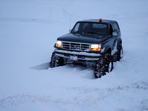 1996 Ford Bronco - This 1996 Ford Bronco is equipped with large off-road tires and is stuck in a snowdrift.