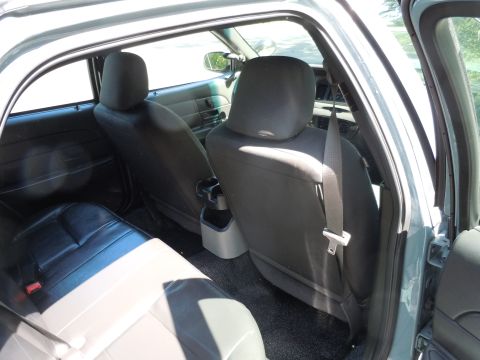 2001 Ford Crown Victoria - Rear interior view of a 2001 Ford Crown Victoria, showing the back seats and door panel.