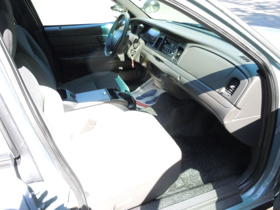 Interior view of a 2005 Ford Crown Victoria, showing the dashboard, steering wheel, and front seats
